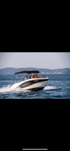 um grupo de pessoas em um barco na água em Speedboat Tours Our Lady Of The Rocks, Perast, Mamula Island and Blue Cave swiming em Tivat