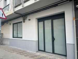 a building with glass doors on the side of it at Aires de Valencia - Spacious 2-Bedroom Apartment in Valencia