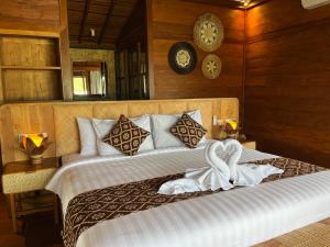 a bedroom with a bed with a towel on it at Villa Gong bali in Ubud