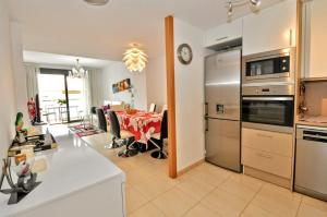 a kitchen and dining room with a table and a dining room at Apartment Verano Go2lloret in Lloret de Mar
