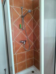 a shower with a hose in a bathroom at Cozy Moroccan House in Agadir +21 photos