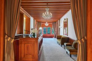 a hallway with a waiting room with a chandelier at Le Castel Marie Louise in La Baule