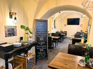 a restaurant with a chalkboard in the middle of a dining room at Braugasthaus in Naumburg