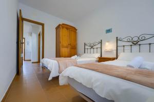 Postel nebo postele na pokoji v ubytování Hostal del Faro