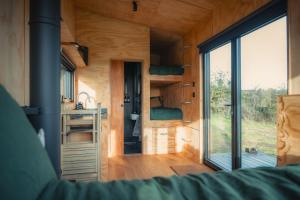 a tiny house with a large window and a bathroom at Altair in Holywell
