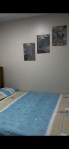 a bedroom with a bed with pictures on the wall at Chalet in Ain Sokhna