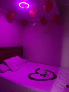 a purple room with a bed with a purple light at Chalet in Ain Sokhna +3 photos