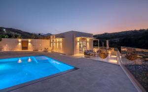 a house with a swimming pool on a patio at Casa Elea in Kissamos