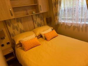 een bed met twee kussens erop in een slaapkamer bij Ardmachree in Burton Bradstock +6 foto's