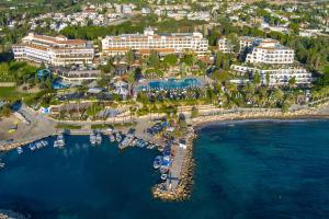 an aerial view of a resort with boats in the water at Coral Beach Hotel & Resort Cyprus in Coral Bay