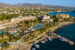 an aerial view of a resort with a marina at Coral Beach Hotel & Resort Cyprus in Coral Bay