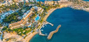 an aerial view of a resort next to the water at Coral Beach Hotel & Resort Cyprus in Coral Bay