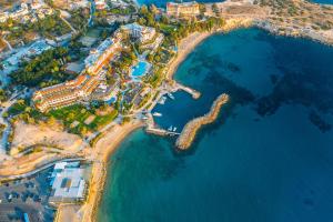 an aerial view of a resort next to the ocean at Coral Beach Hotel & Resort Cyprus in Coral Bay