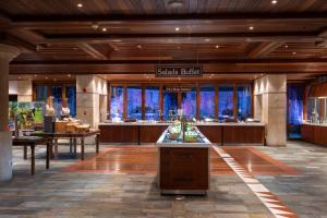 a lobby of a hotel with a buffet in the center at Coral Beach Hotel & Resort Cyprus in Coral Bay