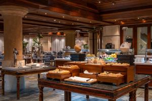 a buffet in a hotel with food on display at Coral Beach Hotel & Resort Cyprus in Coral Bay