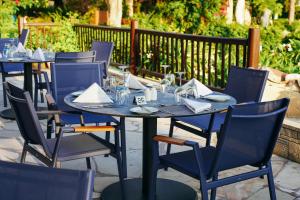 a group of tables and chairs with napkins on them at Coral Beach Hotel & Resort Cyprus in Coral Bay