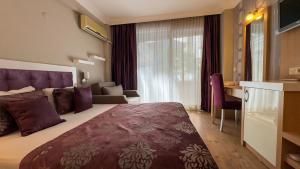 Postel nebo postele na pokoji v ubytování Bilkay Hotel