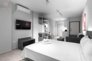 sypialnia z białym łóżkiem i salonem w obiekcie Modeco, Nilie Hospitality MGMT w Salonikach