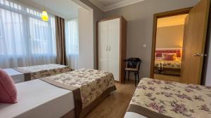Postel nebo postele na pokoji v ubytování Bilkay Hotel