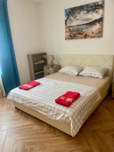 a bedroom with a bed with two red towels on it at Villa Nilić in Bar +43 photos