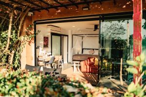a room with a bed and a living room at Bougain Villas - Adults Only in Chiang Dao