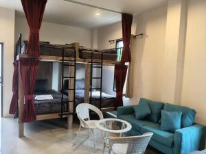 a living room with bunk beds and a couch at ขุนโลหะ K̄hun loh̄a in Phuket