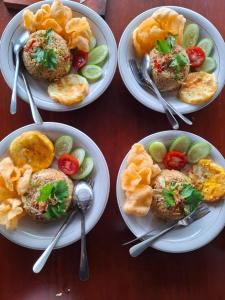 four plates of food on a table with forks and spoons at Seroja Hills Glamping Wonosobo in Kejajar