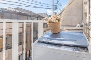 a basket of flowers sitting on a balcony at Near Shinjuku Nakano unit walking 4mins Broadway in Tokyo