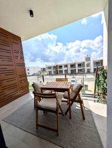 a dining room with a table and chairs and a large window at Modern Luxury Apartment in Aglantzia +5 photos