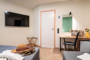 A television and/or entertainment centre at Emily Hotel