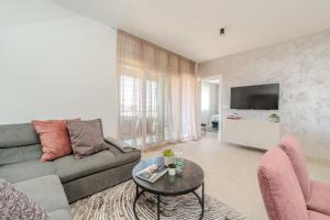 a living room with a couch and a table at Apartment Anna - free private parking in Zadar