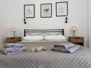a bedroom with a bed with towels on it at Happiness Apartment 7 in Sidari