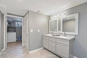 a bathroom with a sink and a mirror at Central Huge Duplex - Sleeps 16 in Wheat Ridge +30 photos