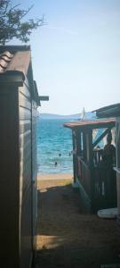 a person sitting on a chair on the beach at Mobile home Ivan Vodice in Vodice