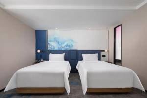 Voodi või voodid majutusasutuse Hampton by Hilton Chengdu Wuhou Waishuannan toas