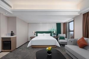 Voodi või voodid majutusasutuse Hampton by Hilton Chengdu Wuhou Waishuannan toas