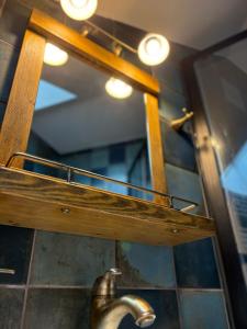 a bathroom mirror with a sink and a faucet at Apartmán Sportheart in Sušice +7 photos