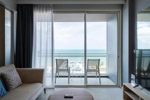 a living room with a view of the ocean at 3BR Seaview - Veranda Pattaya - Luxe in Na Jomtien