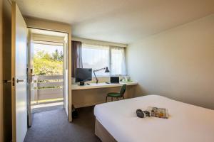 Postel nebo postele na pokoji v ubytování Hôtel Campanile Strasbourg Aéroport Lingolsheim + 29 fotografií