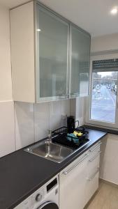 a kitchen counter with a sink and a window at 3 Zimmer Apartment in Wiesbaden in Wiesbaden