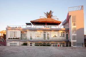 a building with a palm tree on top of it at Phuong Nam Guest House in Mui Ne