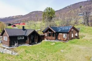 an aerial view of a home with a mountain in the background at Cottage Yard - cozy Cabin in Geilo