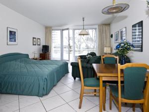 a bedroom with a bed and a table and chairs at Ferienwohnungen im Hotel Royal in Timmendorfer Strand