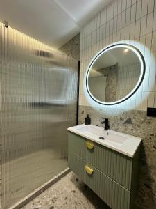 a bathroom with a sink and a mirror at Apartament ShipYard Loft Gdańsk by TriApart in Gdańsk