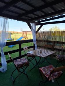 a patio with a table and chairs and a playground at Siedlisko Kalimera in Orzysz