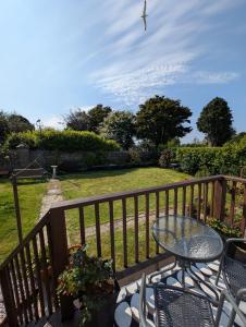 a patio with a table and chairs on a balcony at The Garden Room at Dartmouth in Dartmouth