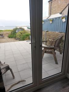 a sliding glass door with a view of the ocean at The Beach House Annalong Cosy beachview cottage in Annalong