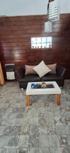 a living room with a couch and a coffee table at Ana home's in Mar del Plata +1 photo