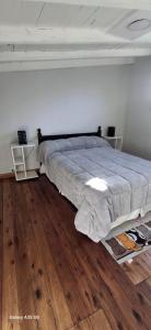 a bedroom with a large bed with a wooden floor at Ana home's in Mar del Plata