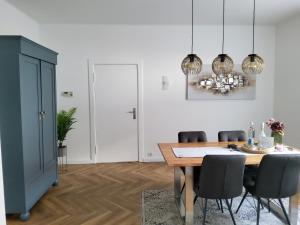 a dining room with a table and chairs at Elbe-Appartements Prignitz #1 in Wittenberge